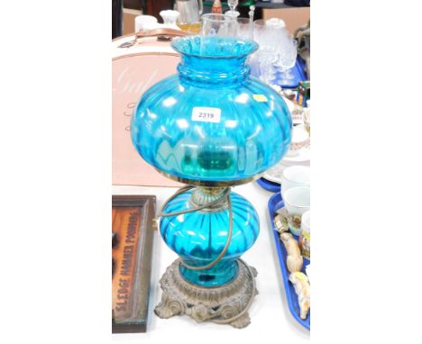 A blue glass oil lamp table lamp. 