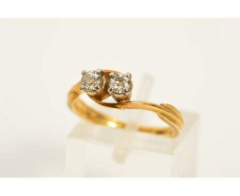 A DIAMOND CROSS OVER RING, designed as two old cut diamonds each within four claw settings to the cross over shoulders, estim