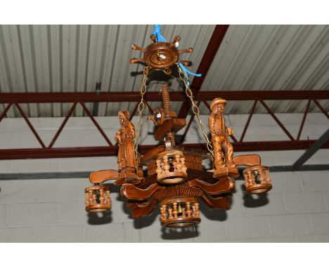 AN OAK EIGHT BRANCH CHANDELIER, the top with a ship wheel adjoining a lower section bearing four standing gentleman and four 