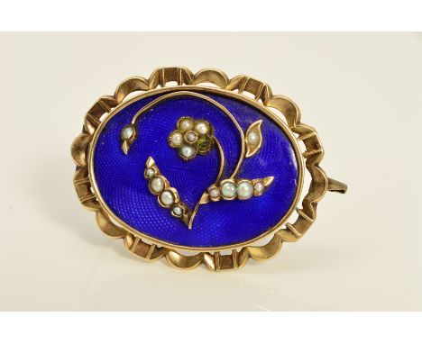 A MID VICTORIAN GOLD MEMORIAL BROOCH, blue enamel inlaid with floral seed pearl detail, oval shape with scalloped edge measur