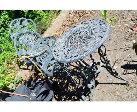 AN ALUMINIUM CIRCULAR GARDEN TABLE (diameter 59cm), with floral patterns together with two matching chairs (3)