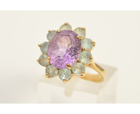 A 9CT GOLD GEM CLUSTER RING, designed as a central oval amethyst within a circular aquamarine surround, with 9ct gold hallmar