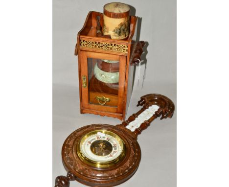 AN EDWARDIAN OAK SMOKERS CABINET, hinged pipe racks to the sides, glazed door enclosing tobacco jar and drawer, height 32cm, 