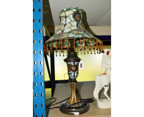 A REPRODUCTION LEADED GLASS TABLE LAMP, fringed shade