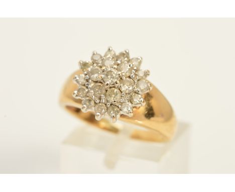 A 9CT GOLD DRESS RING designed as a tiered cluster of claw set, brilliant cut diamonds to the tapered band, with 9ct hallmark