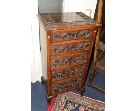 AN EARLY 20TH CENTURY CARVED OAK CHEST OF FIVE SHORT DRAWERS, ring handles, on four cabriole legs, width 53.5cm x depth 37.5c