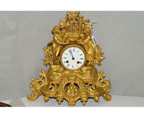 A VICTORIAN GILT METAL FIGURAL MANTEL CLOCK, enamel dial, eight day movement, bell strike, height 33cm, s.d.