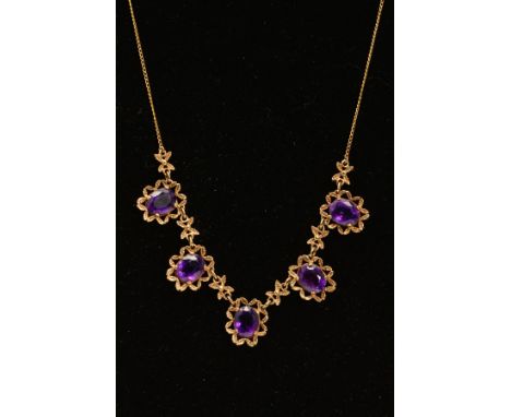AN AMETHYST NECKLACE, designed as five oval amethysts each within an openwork textured scalloped surround, interspaced by tex