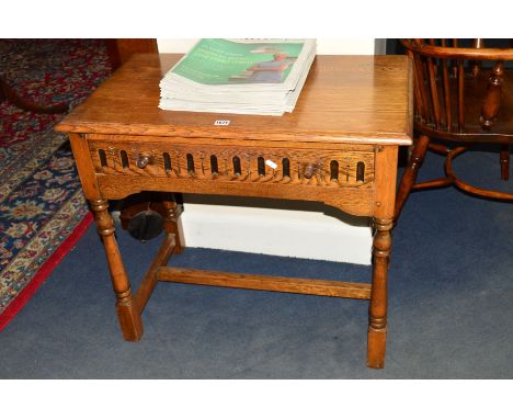 A REPRODUCTION GOLDEN OAK SIDE TABLE, with a single drawer, width 79cm x depth 46cm x height 69cm 