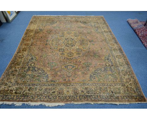 A 20TH CENTURY TURKESTAN CARPET SQUARE, russet ground, central motif and multi strap border, hanging label verso, 350cm x 272