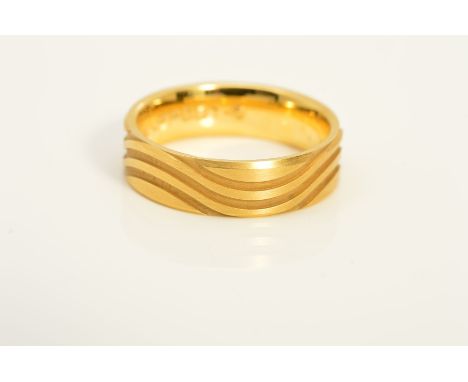 A MODERN 18CT GOLD WEDDING BAND, wave groove design in a satin finish, measuring approximately 6mm in width, ring size R 1/2,