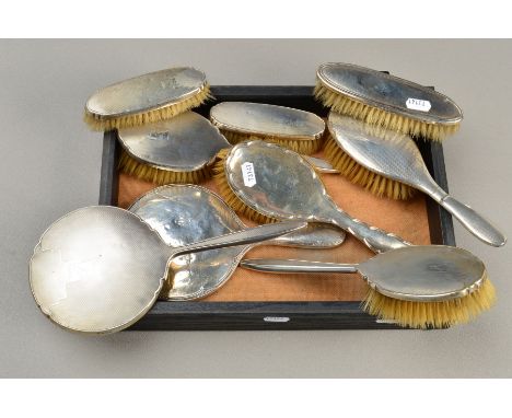 A GEORGE VI FIVE PIECE SILVER BACKED DRESSING TABLE SET, comprising hand mirror and four brushes, Birmingham 1937/38, togethe