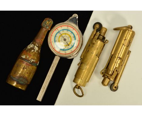 FOUR MISCELLANEOUS ITEMS, to include two WWI lighters, a base metal champagne bottle shaped sifter type item and a rolling me