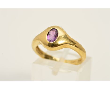 A 9CT GOLD AMETHYST RING, designed as an oval, flush set amethyst, to the plain band, with 9ct hallmark, ring size O, approxi