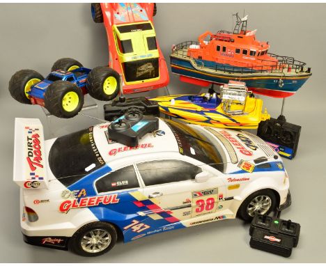 A QUANTITY OF RADIO CONTROLLED TOYS, to include a large scale B.M.W. Rally Car, R.N.L.I Lifeboat, Sand Eagle II buggy etc, so