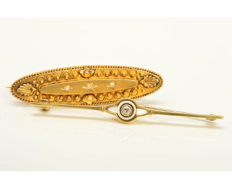 TWO EARLY 20TH CENTURY GOLD DIAMOND BROOCHES, the first of elongated, oval outline, set to the centre with three single cut d