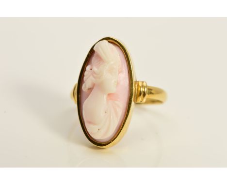 A CAMEO RING, the elongated oval cameo within a collet setting, depicting a lady in profile, stamped 18, ring size H, approxi