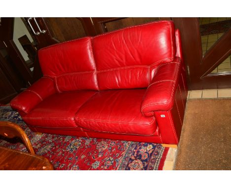 A MODERN RED LEATHER SOFA, with stitched detail, on light wood feet, length 198cm x depth 93cm x height 92cm 