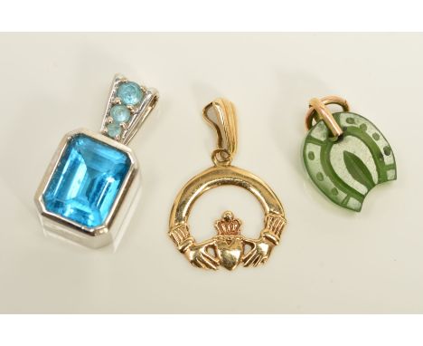 THREE PENDANTS, the first a curved Claddagh design, the second a panel of nephrite jade carved into a horse shoe, the third a