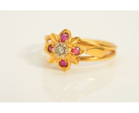 A DIAMOND AND RUBY CLUSTER RING, designed as a central single cut diamond within a star setting above a flower shape surround