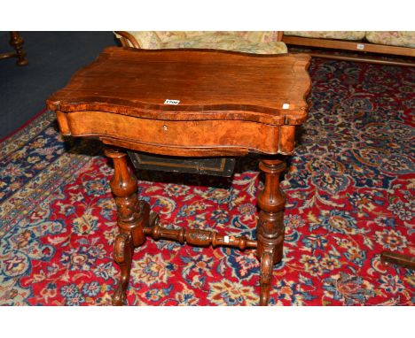 A VICTORIAN WALNUT WORK TABLE OF SHAPED RECTANGULAR FORM, hinged top opening to reveal a fitted interior with fret carved cov