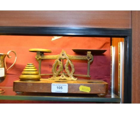 A set of brass and oak postal scales
