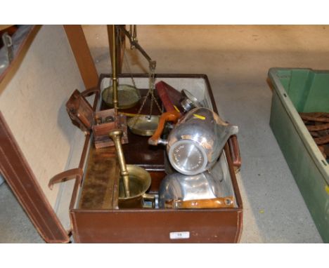 A brown leather suitcase containing a piquotware teaset; a set of mahogany and brass scales; an Art Deco chrome cased mantel 