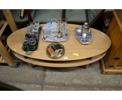 A modern light oak oval topped coffee table 