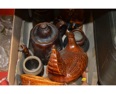 A box containing a treacle glazed teapot and various stoneware jars