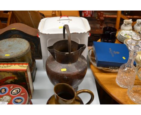 An enamel bread bin; and two copper jugs 