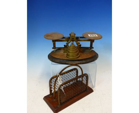 AN EDWARDIAN SET OF BRASS POSTAGE SCALES WITH WEIGHTS, TOGETHER WITH A LETTER RACK OF THE SAME PERIOD.
