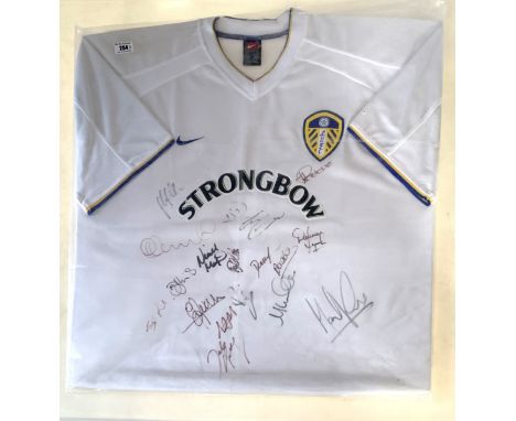 Leeds United signed shirt - Strongbow 2000/2001 season, signed by players inc. Lucas Radebe, on board in plastic but no frame