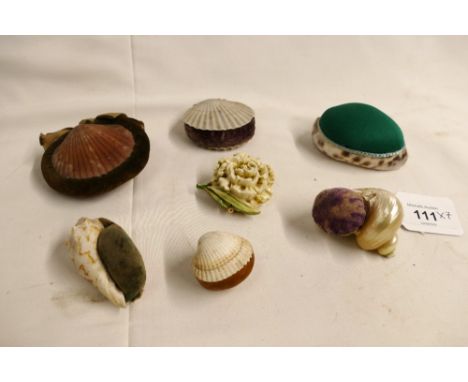 Six vintage novelty shell formed pincushions and a flower shaped embellishment