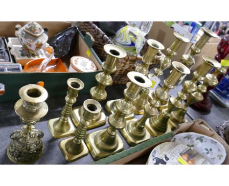 Five pairs of brass candlesticks and a singular ornate candlestick