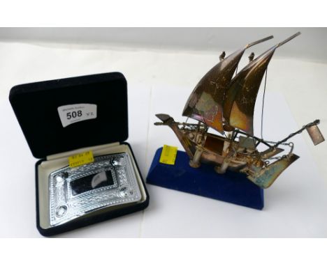 A ClanArt Scottish Celtic belt buckle and a small model of a ship, marked to the rudder silver 925