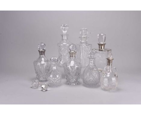 A group of eight cut and plain glass decanters, including four with silver collars, two hallmarked for Peter John Doherty, Bi