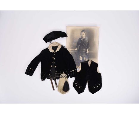 A Victorian child's black velvet jacket and waistcoat with accompanying photograph of the original owner wearing these items,