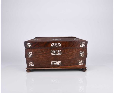 A Victorian rosewood tea caddyOf sarcophagus form with twin ring handles, inlaid with mother-of-pearl flowers and foliage, th