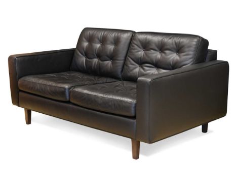 Paola Navone for Contempo, a black leather Urano two-seat sofa, with button studded seat and back cushions raised on dark sta