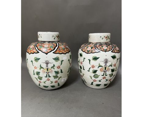 An associated pair of Chinese porcelain ginger jars with lids, one bearing four character Kangxi mark, height 31cm.Condition: