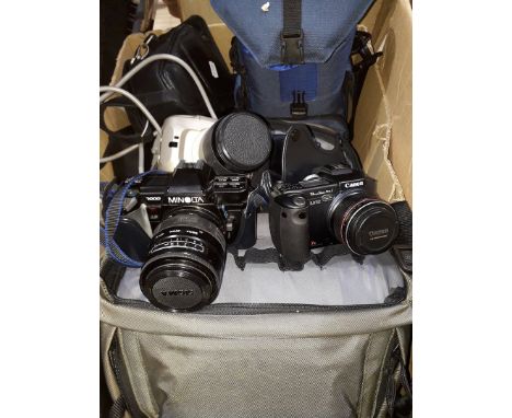 A collection of various cameras, lenses and photography equipment including Minolta 7000 camera, etc. 