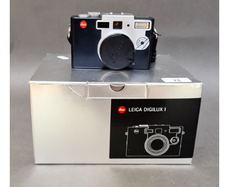 A Leica Digilux 1 digital camera with AC adapter / charger, instructions manual, a USB 2.0 multi-card reader software CD, a A