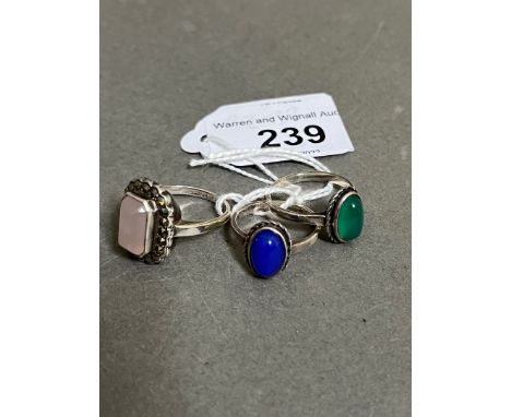 A group of three rings marked 'Silver', one set with a chrysoprase cabochon, another a blue stained quartz cabochon and a ros