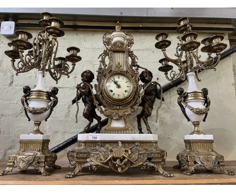 A brass and marble Imperial Brevattato mantel clock with candelabra garniture, height 25inches.Condition:- General wear throu