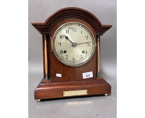 A mahogany cased mantel clock with brass columns, on ball feet, with pendulum, no key. 