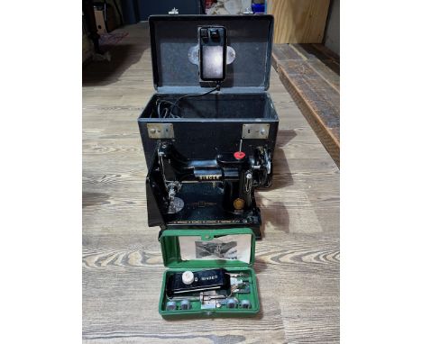 A Singer Featherweight 221 sewing machine with cable, pedal, accessories together with a Singer Buttonholer No. 160506, model