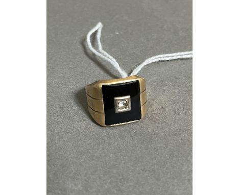 A gent's 'black onyx' signet ring marked '10K', gross wt. 4.75g.Size:- M