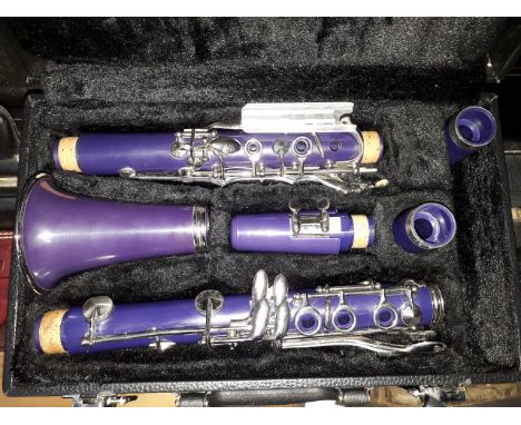 A Virtuosi purple clarinet with hard case. 