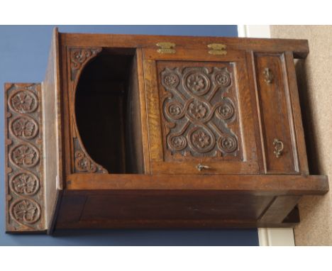 19th century carved oak side cabinet with single panelled cupboard, with guilloche and scrolling flower head decoration, W55c