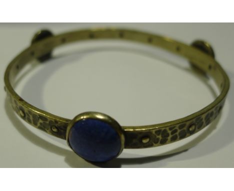 An Arts and Crafts hammered pewter bangle